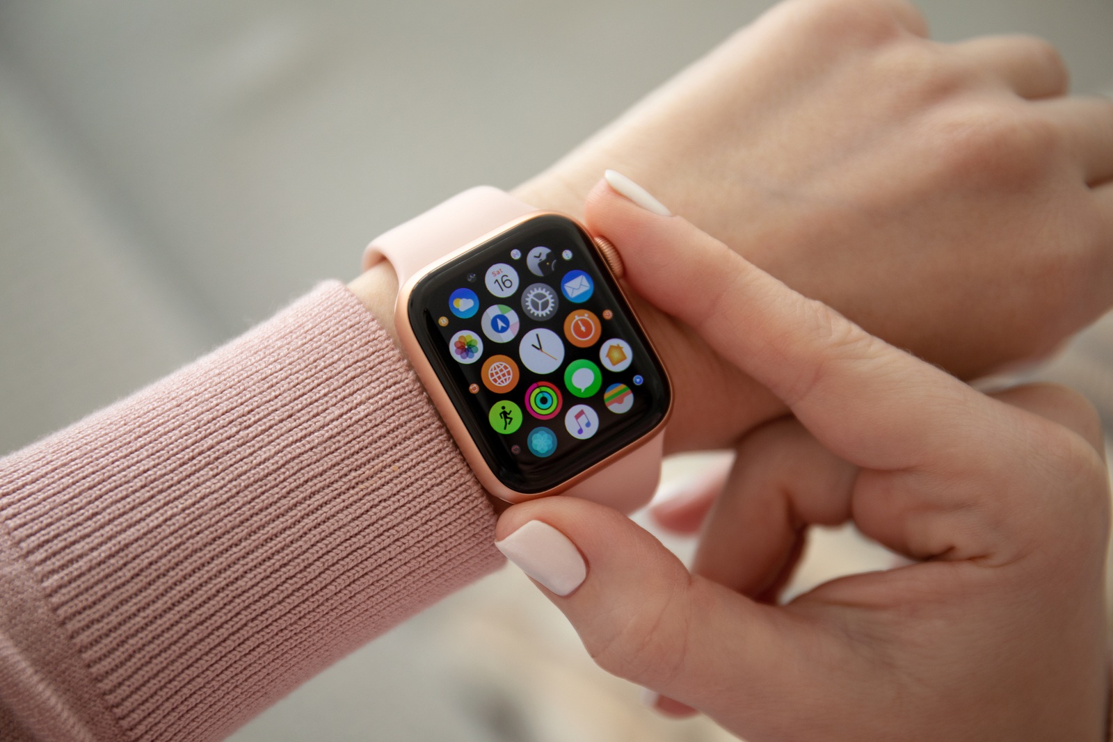 Anapa, Russia - February 16, 2019: Woman hand with Apple Watch Series 4 and finger touching screen. Apple Watch was created and developed by the Apple inc.