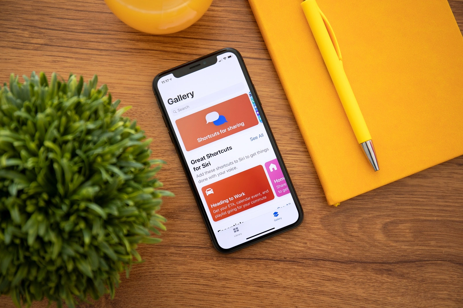 Alushta, Russia - October 8, 2018: iPhone X with home screen app Shortcuts. iPhone 10 was created and developed by the Apple inc.