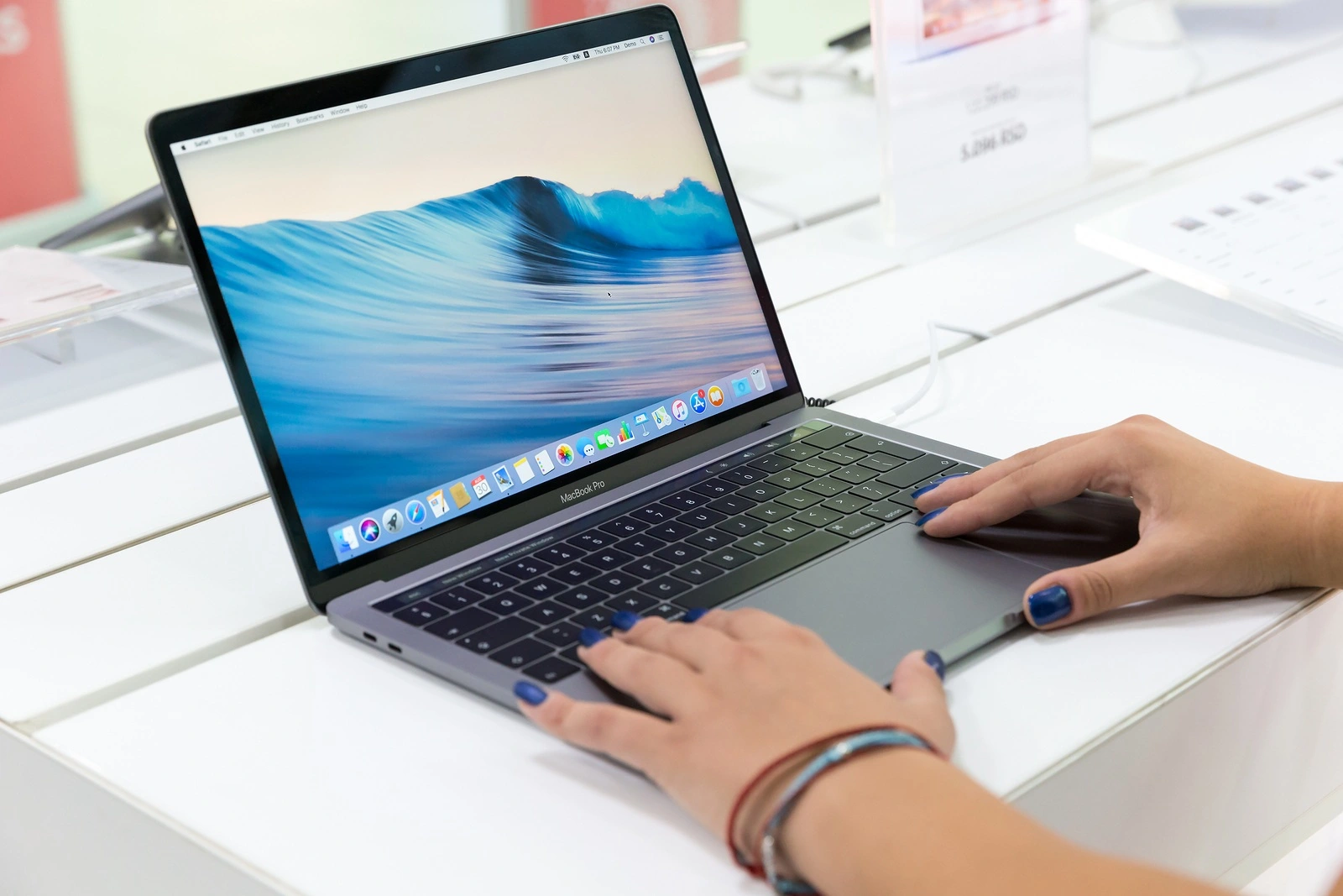 Belgrade, Serbia - August 30, 2018: New MacBook Pro laptop with macOS on the screen is shown on retail display in electronic store.