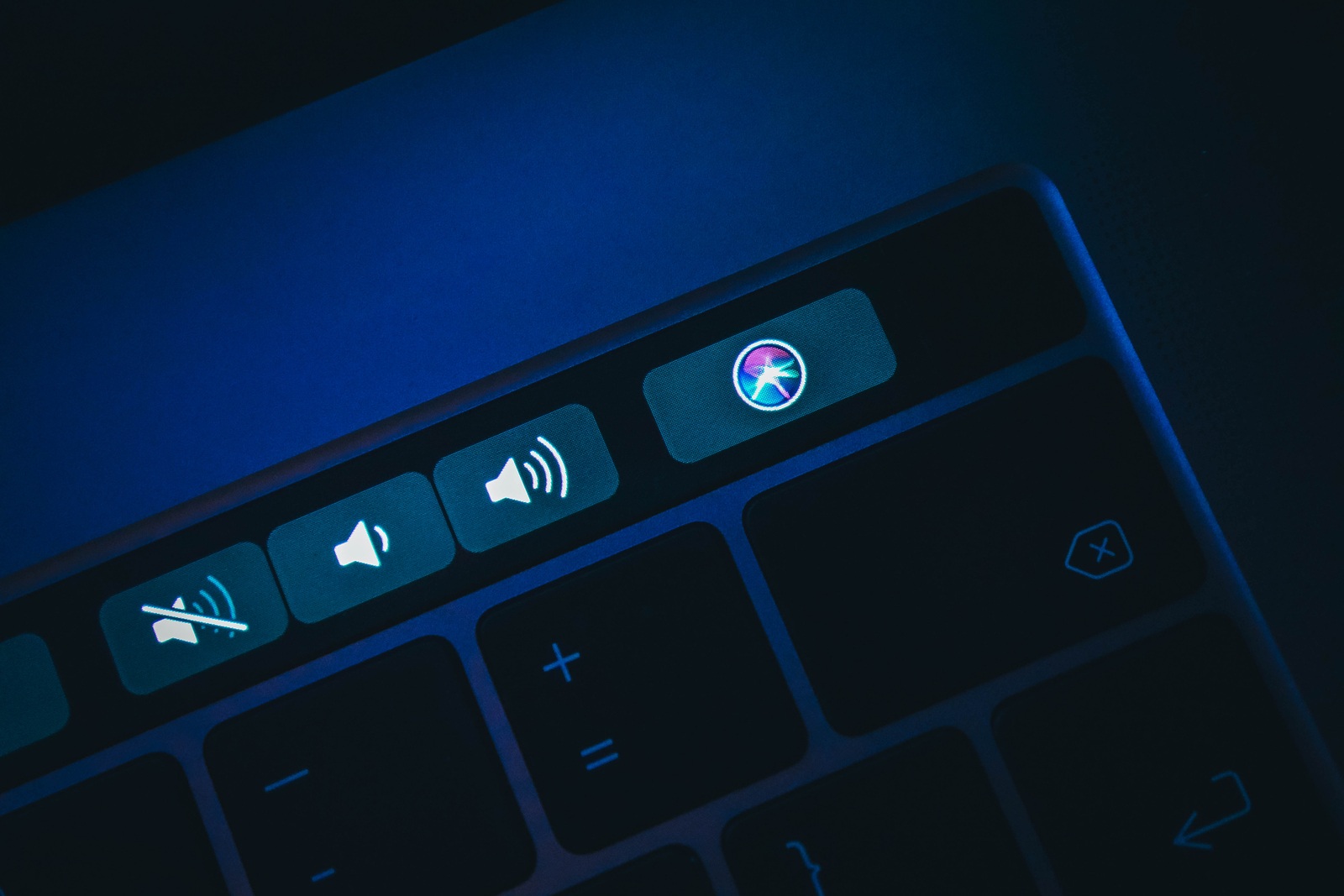 France, Paris - June 25, 2018:  New Siri icon application button on the Touch Bar  of macbook keyboard, close-up.