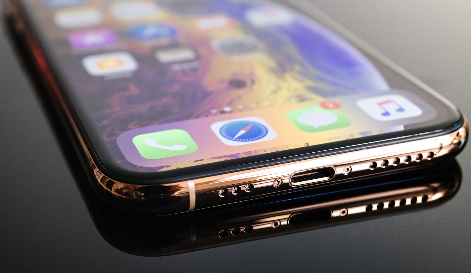 PARIS, FRANCE - SEP 25, 2018: New iPhone Xs and Xs Max smartphone model by Apple Computers close up lighting connector close-up macro of golden version - macro artistic photo