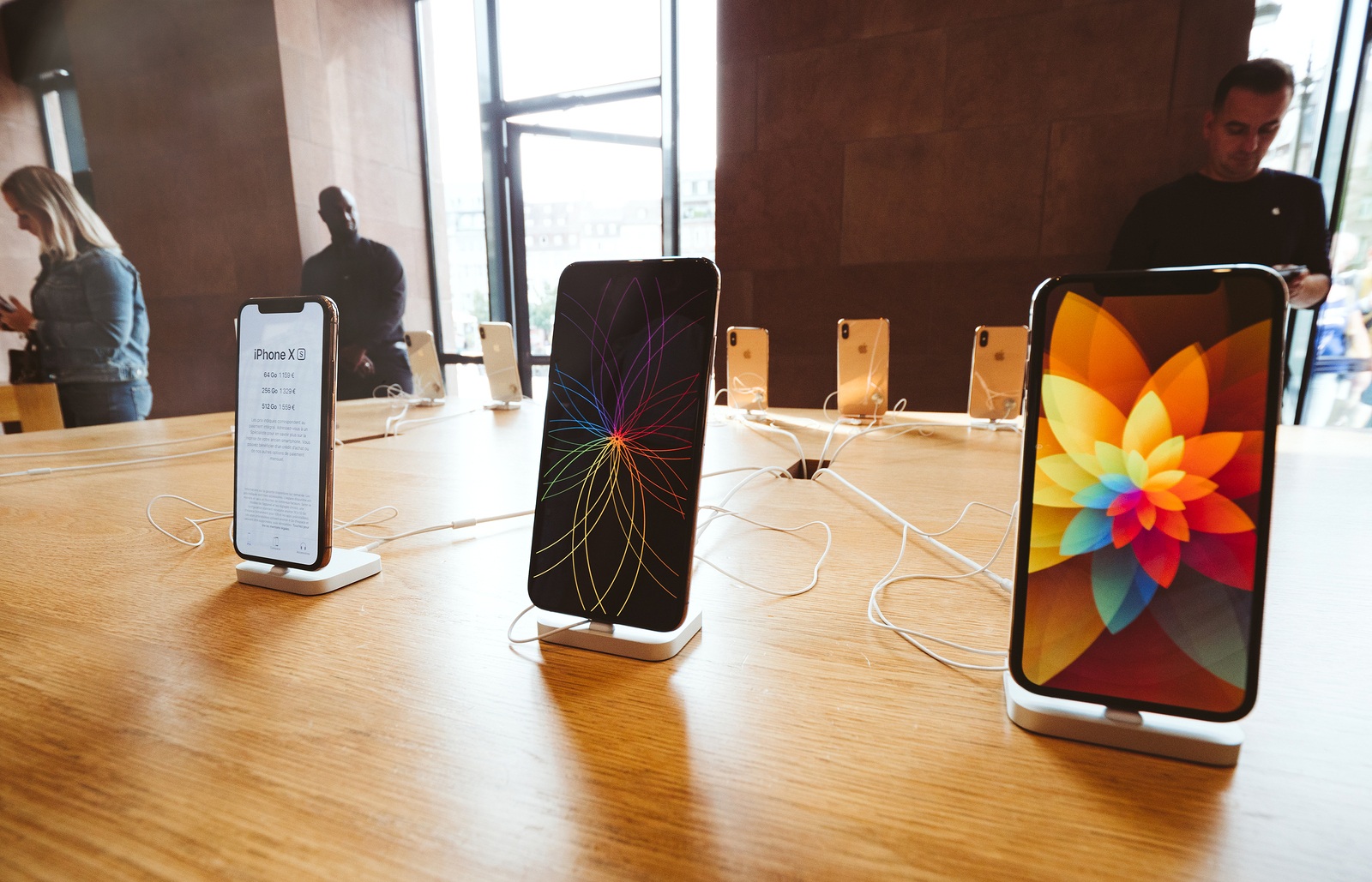 STRASBOURG, FRANCE - SEP 21, 2018: Row of new iPhones in Apple Store with customers people buying admiring the new latest iPhone Xs and Xs Max preorder for Xr and Watch Series 4 wearable