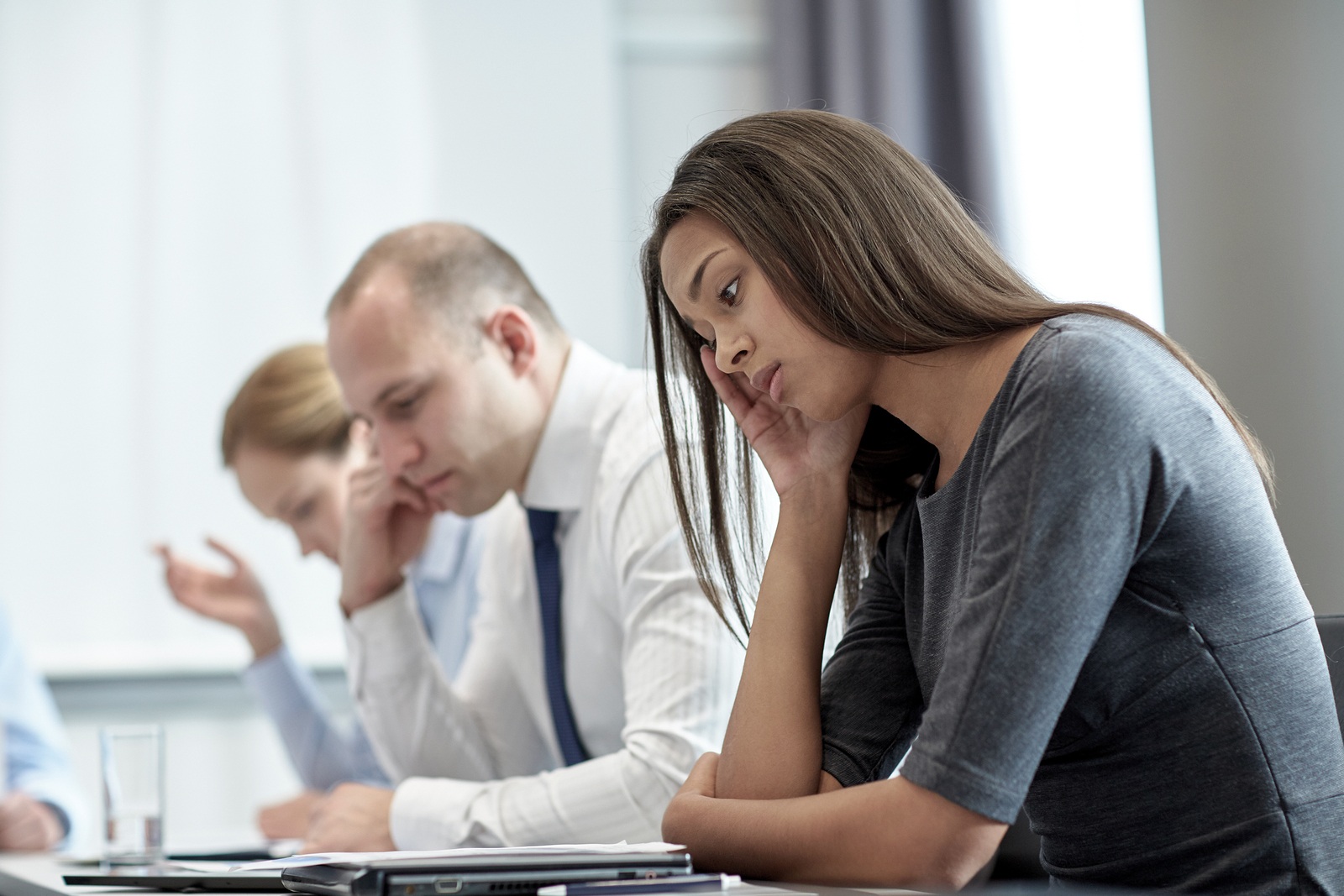 business, teamwork, people and crisis concept - business team sitting sad and solving problem in office