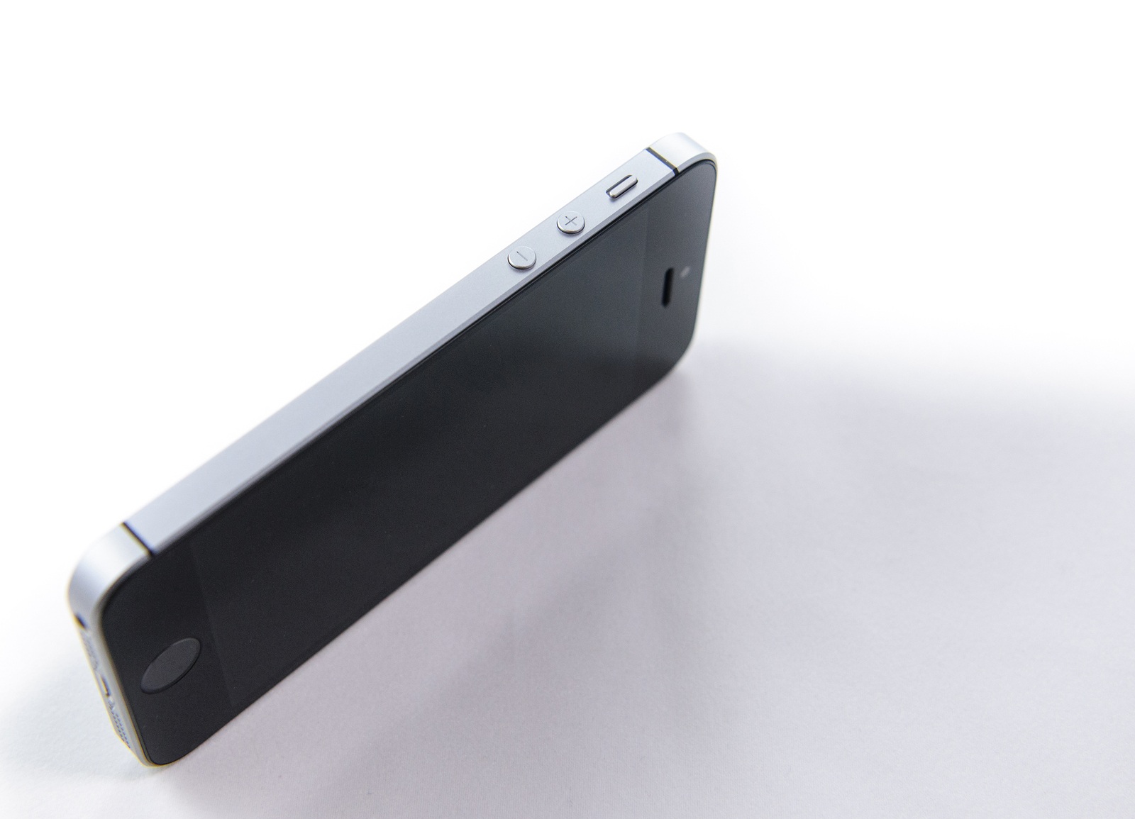 PARIS FRANCE - APR 21 2016: Side view of the new Apple iPhone SE combining the updated processor 4K rear camera touch id retina display