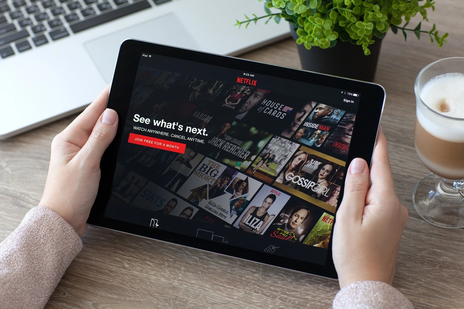 Alushta Russia - October 9 2016: Woman holding a iPad Pro Space Gray with multinational entertainment company Netflix provides streaming media and video on the screen. iPad Pro 9.7 was created and developed by the Apple inc.