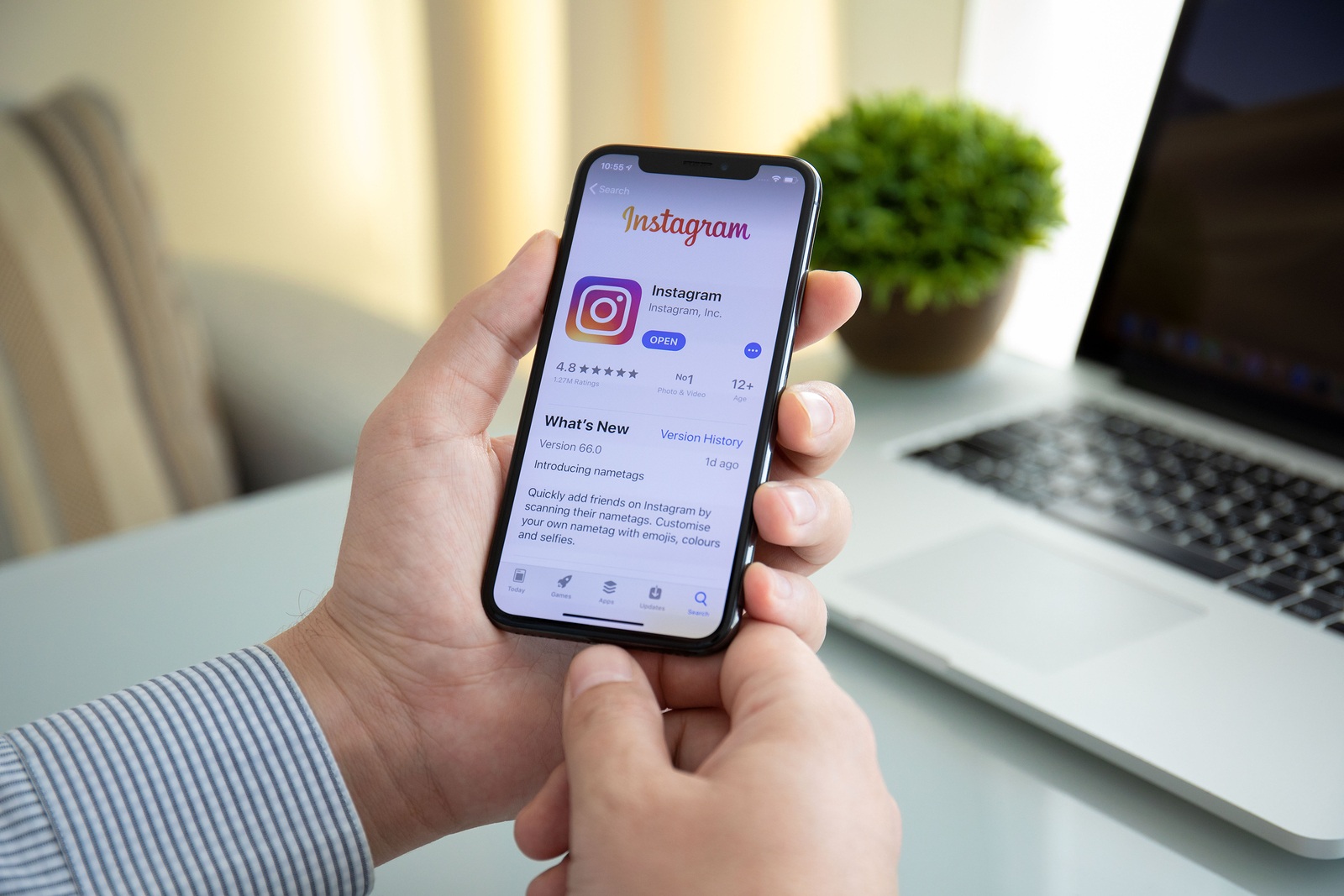 Alushta, Russia - October 9, 2018: Man hand holding iPhone X with social networking service Instagram on the screen. iPhone 10 was created and developed by the Apple inc.