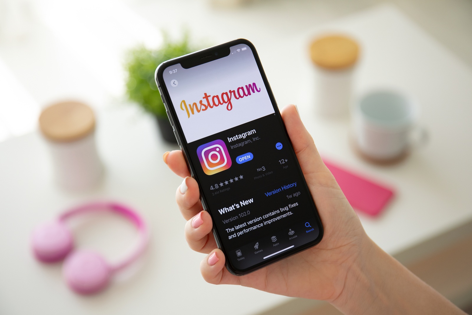 Anapa, Russia - July 22, 2019: Woman hand holding iPhone X with social networking service Instagram on the screen. iPhone was created and developed by the Apple inc.