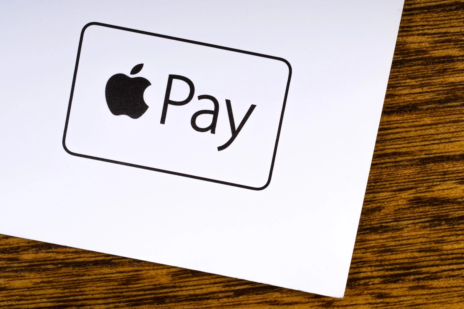 LONDON, UK - MARCH 27TH 2018: A close-up of the Apple Pay logo, pictured on the bottom of a leaflet, on 27th March 2018. Apple Pay is a mobile payment and digital wallet service by Apple Inc.