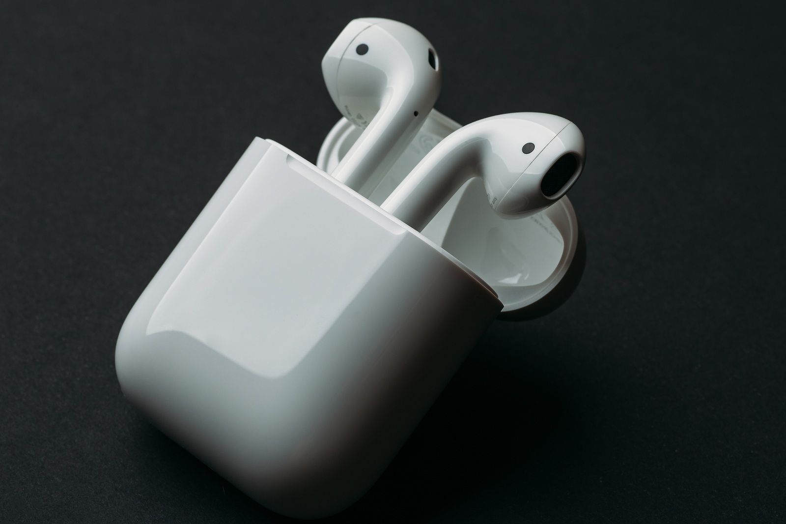 Moscow, Russia - Circa December 2018: Apple AirPods - wireless bluetooth earphones or headphones and white box for storage and charging, use with Iphone, Ipad or Mac.