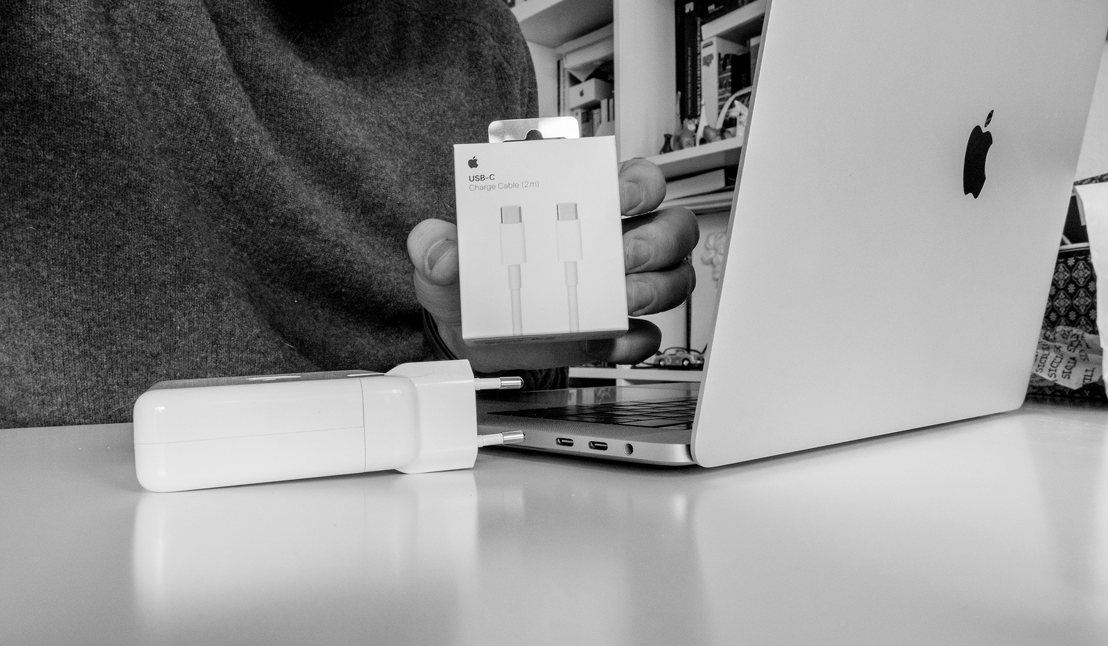 PARIS, FRANCE - FEB 23, 2018: Man unboxing Apple Computers USB-C charging cable bought to power the latest MacBook Pro laptop