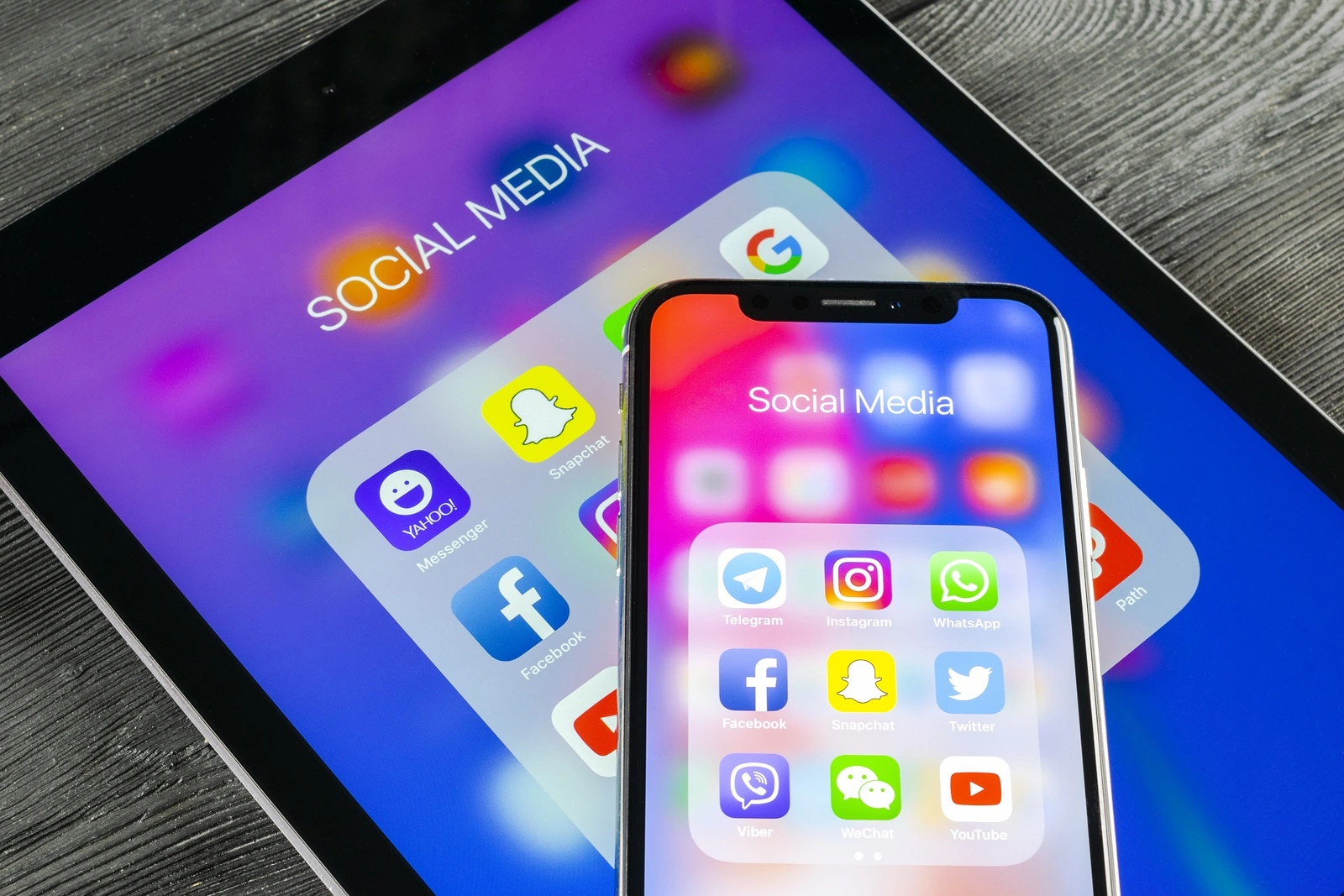 Sankt-Petersburg, Russia June 8, 2018: Apple iPhone X and iPad with icons of social media facebook, instagram, twitter, snapchat application on screen. Social media icons. Social network. Social media