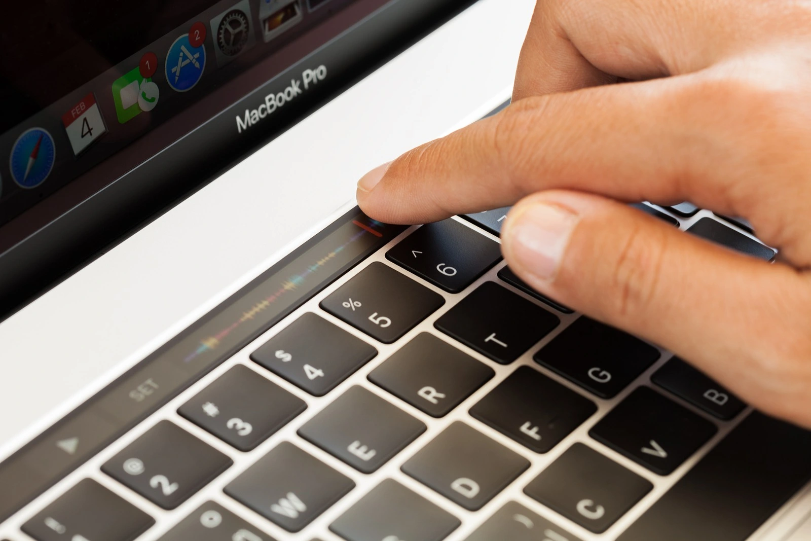 Bangkok Thailand - january 5 2017: Close-up hand touching touch bar on macbook pro 2016 mixing audio sound touch bar is new function on macbook pro 2016 by apple Inc.