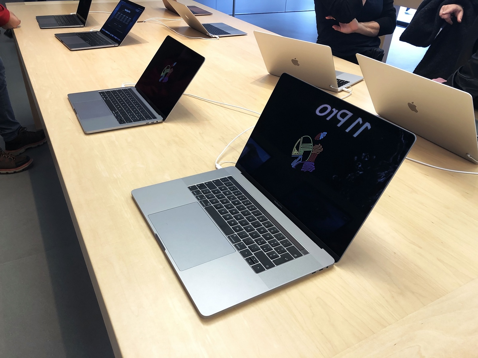 November 2019 Bologna, Italy: Macbooks computers on display in Apple store close-up across shoppers. Apple computers screens on tables