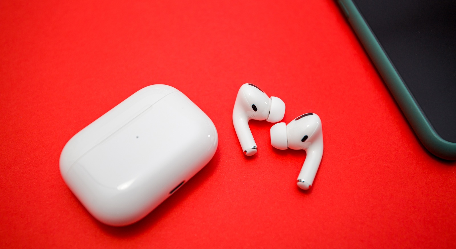 Paris, France - Oct 30, 2019: Charging case and the new iPhone 11 Pro next to New Apple Computers AirPods Pro headphones with Active Noise Cancellation for immersive sound