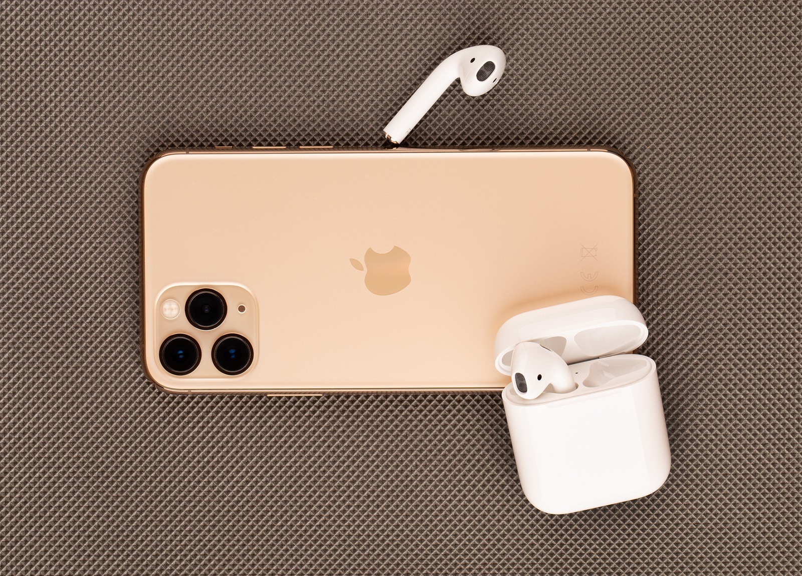 Rostov-on-Don, Russia - october 2019. Apple iPhone 11 Pro on a wooden surface. Apple's new smartphone close-up. Smartphone and AirPods earphones.