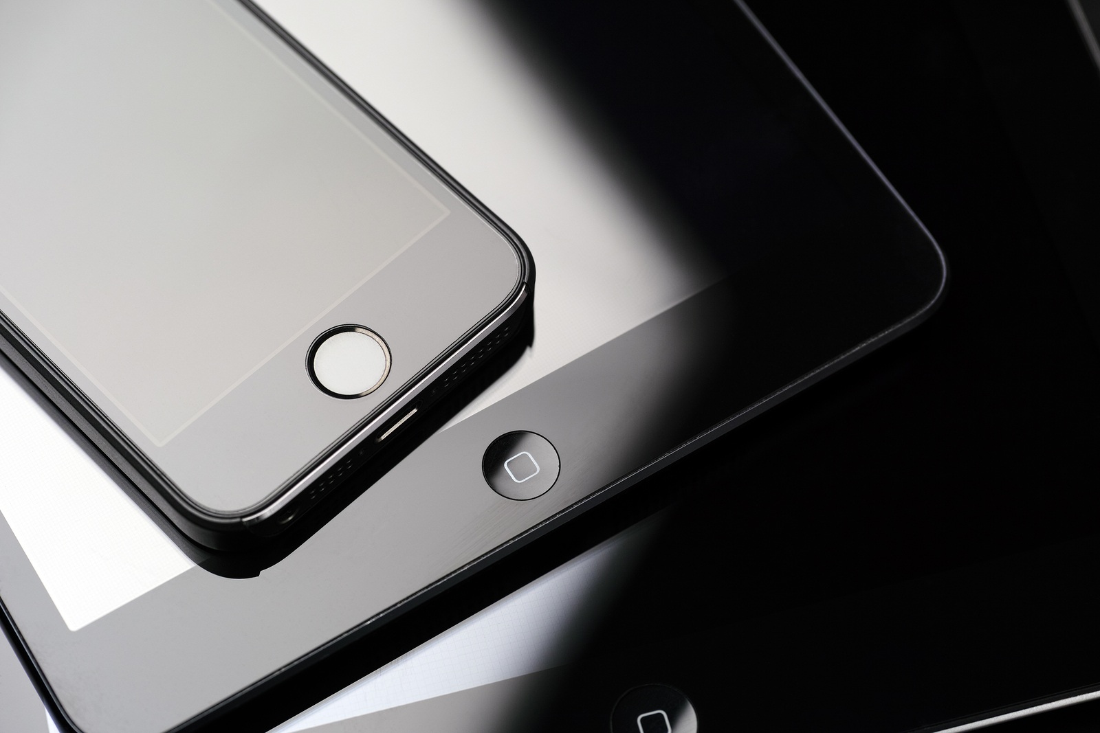 Tambov, Russian Federation - February 26, 2015 Close up of stack of Apple devices - iPhone 5s, iPad mini and iPad 2. Studio shot.