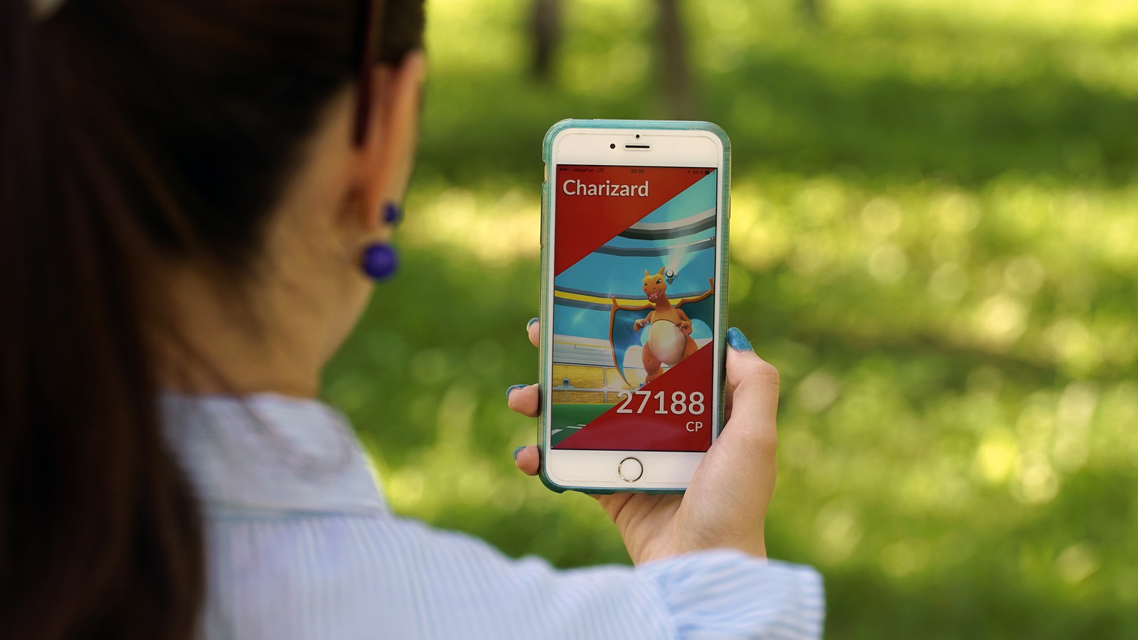Samara, Russia - July 4, 2017: woman playing pokemon go on his iphone 6s plus. pokemon go multiplayer game with elements of augmented reality.