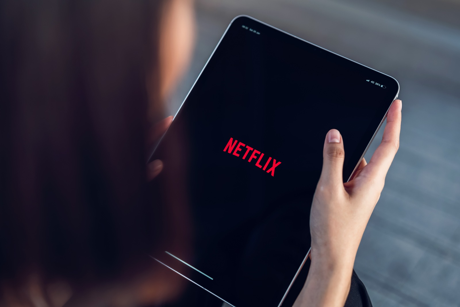 Bangkok, Thailand - March 11, 2019 : women use Netflix app on Ipad pro screen. Netflix is an international leading subscription service for watching TV episodes and movies.