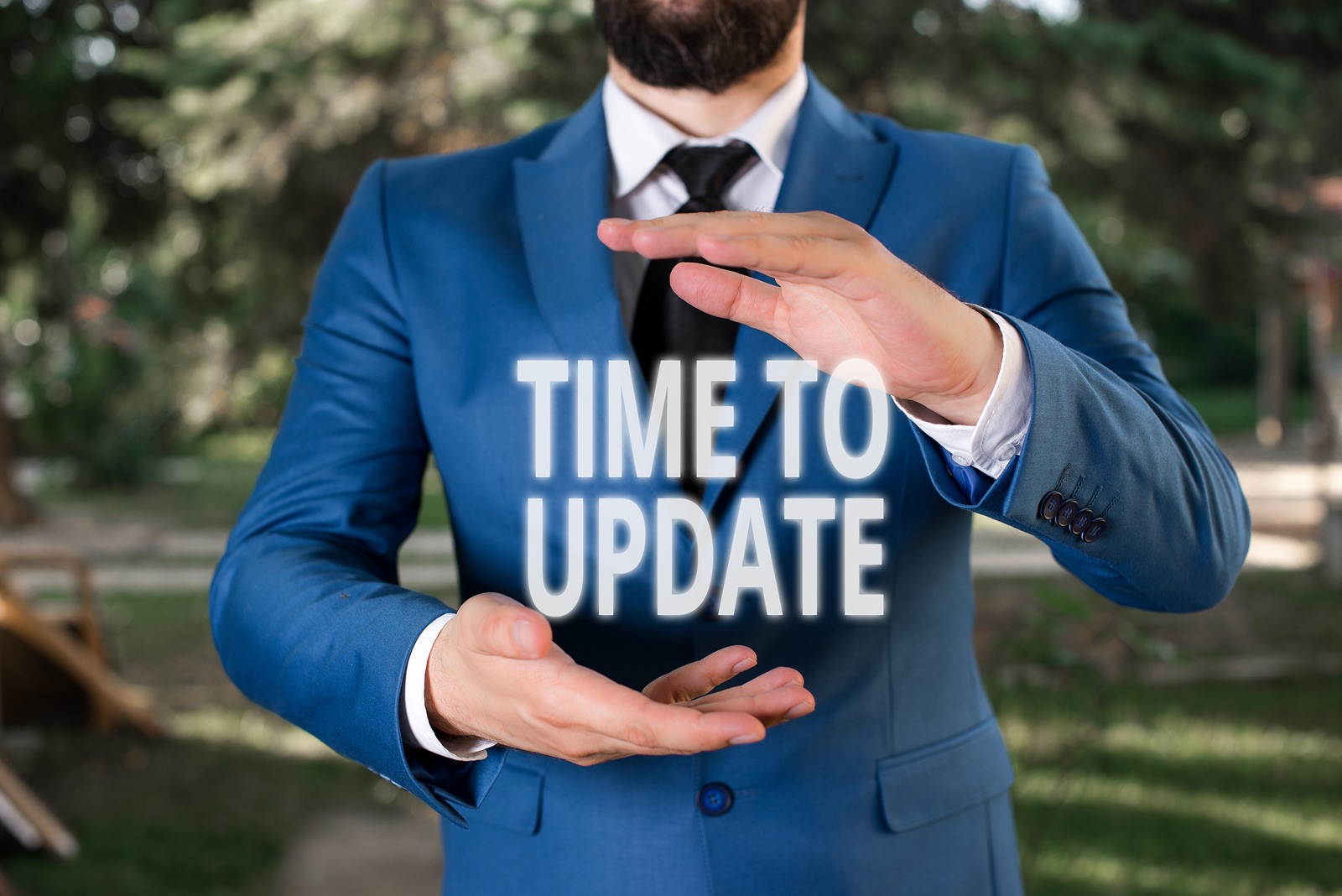 Handwriting text Time To Update. Concept meaning act updating something someone or updated version program Man with opened hands stands in suite. Concept with copy space and man.