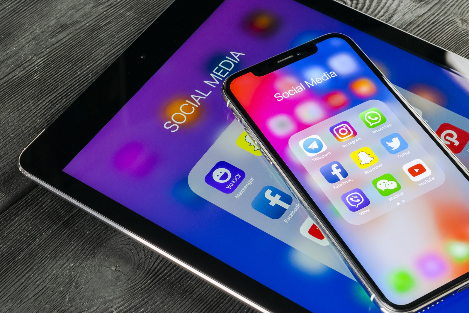 Saint-Petersburg, Russia June 8, 2018: Apple iPhone X and iPad with icons of social media facebook, instagram, twitter, snapchat application on screen. Social media icons. Social networks. Social media