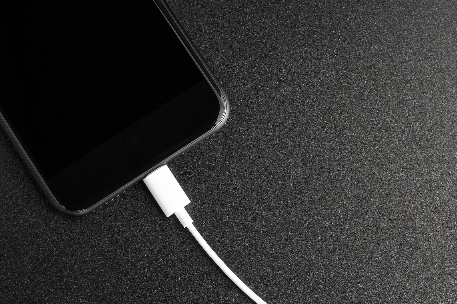 phone connecting usb port on black background top view