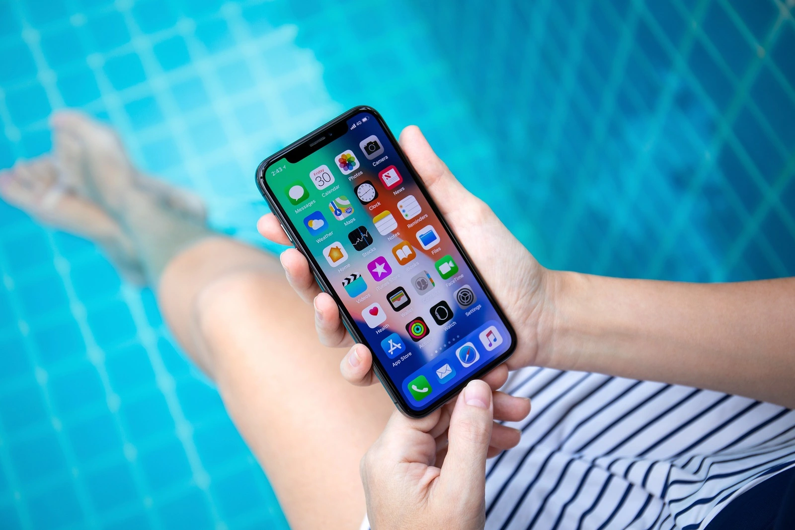 Koh Samui, Thailand - March 30, 2018: Woman hand holding iPhone X with IOS 11 on the screen. iPhone 10 was created and developed by the Apple inc.
