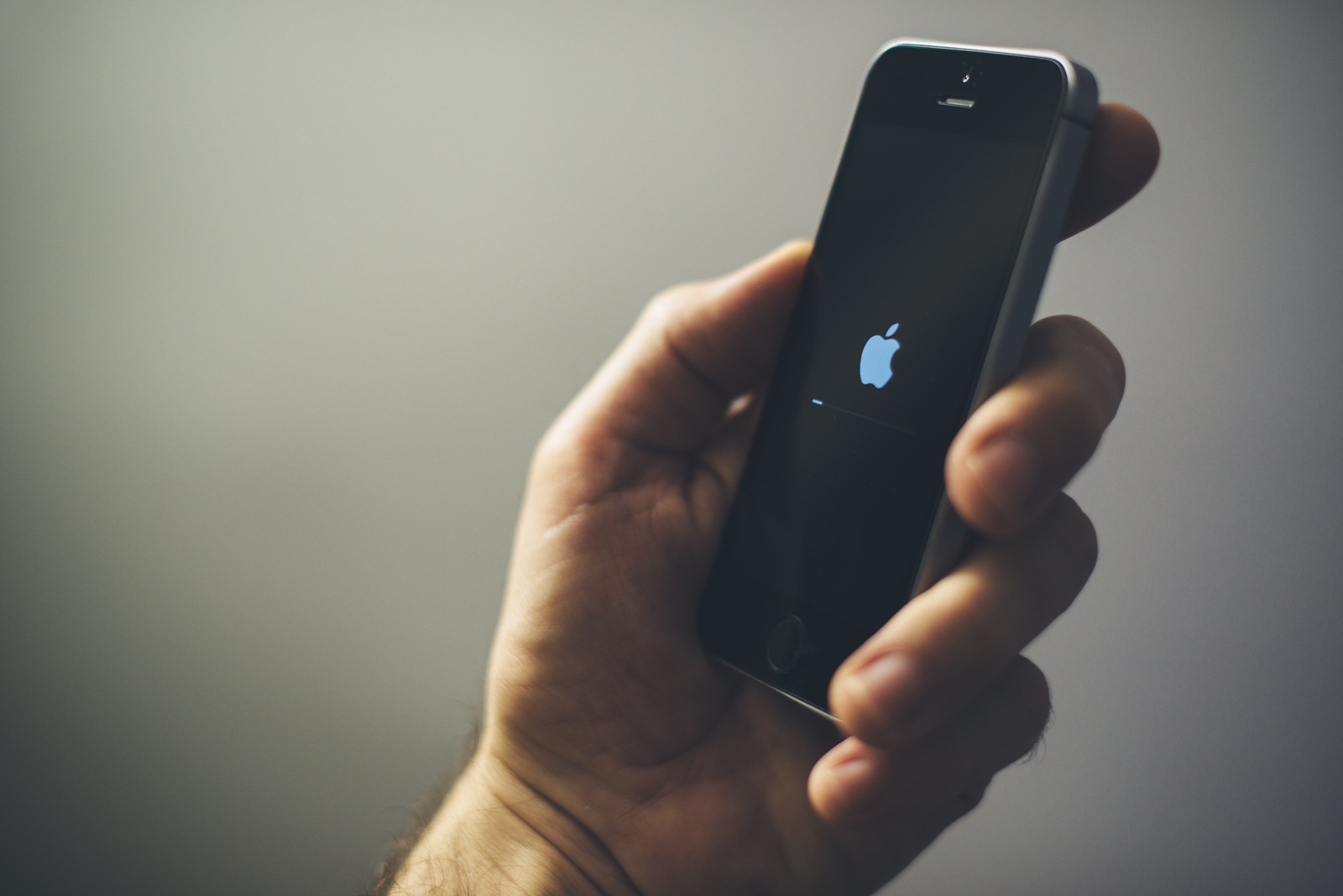 NOVI SAD, SERBIA - MARCH 06, 2018: Apple iPhone SE mobile phone in male hand, illustrative editorial. This model of smart phone was re-released with new improved options on March 24, 2017.