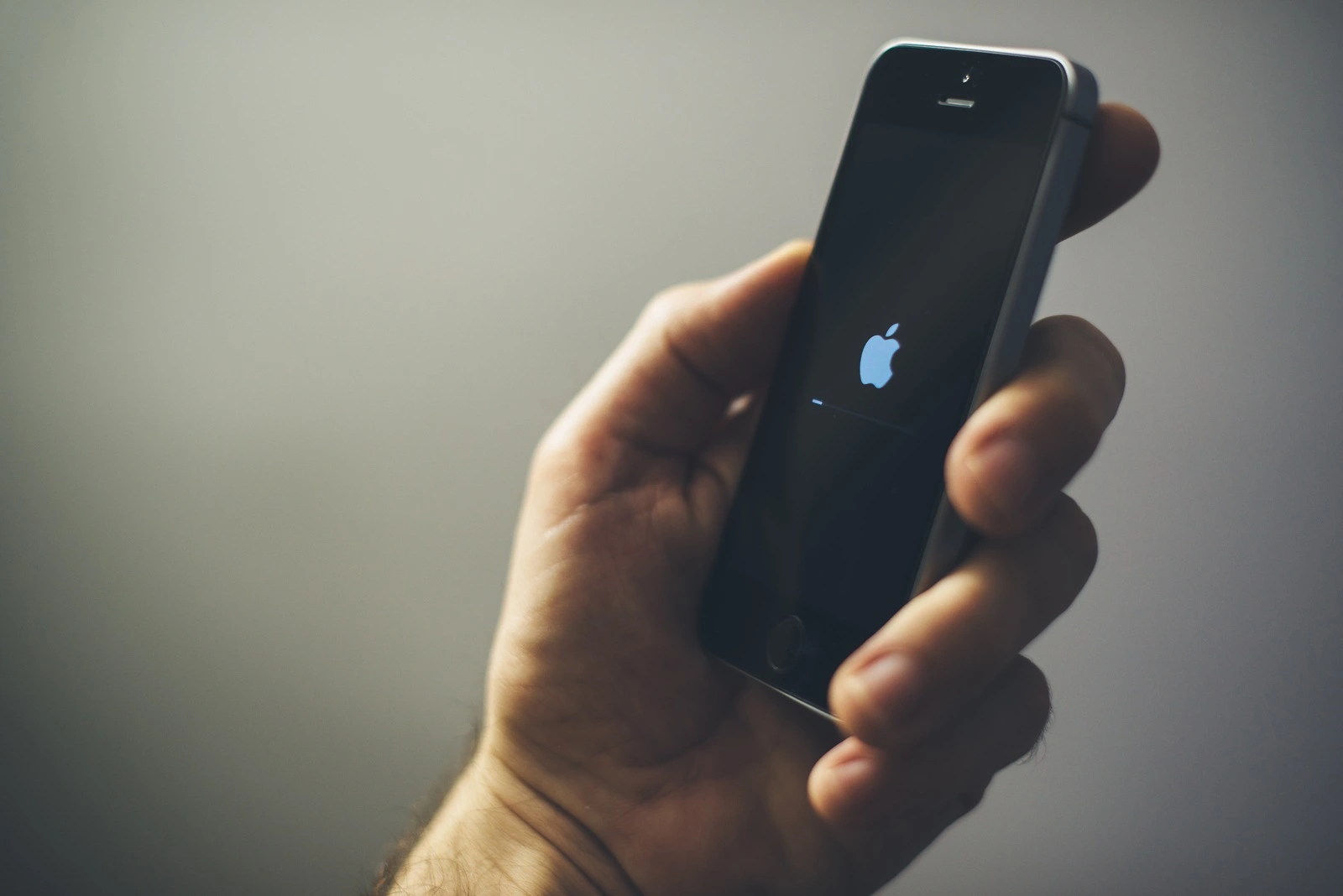 NOVI SAD, SERBIA - MARCH 06, 2018: Apple iPhone SE mobile phone in male hand, illustrative editorial. This model of smart phone was re-released with new improved options on March 24, 2017.