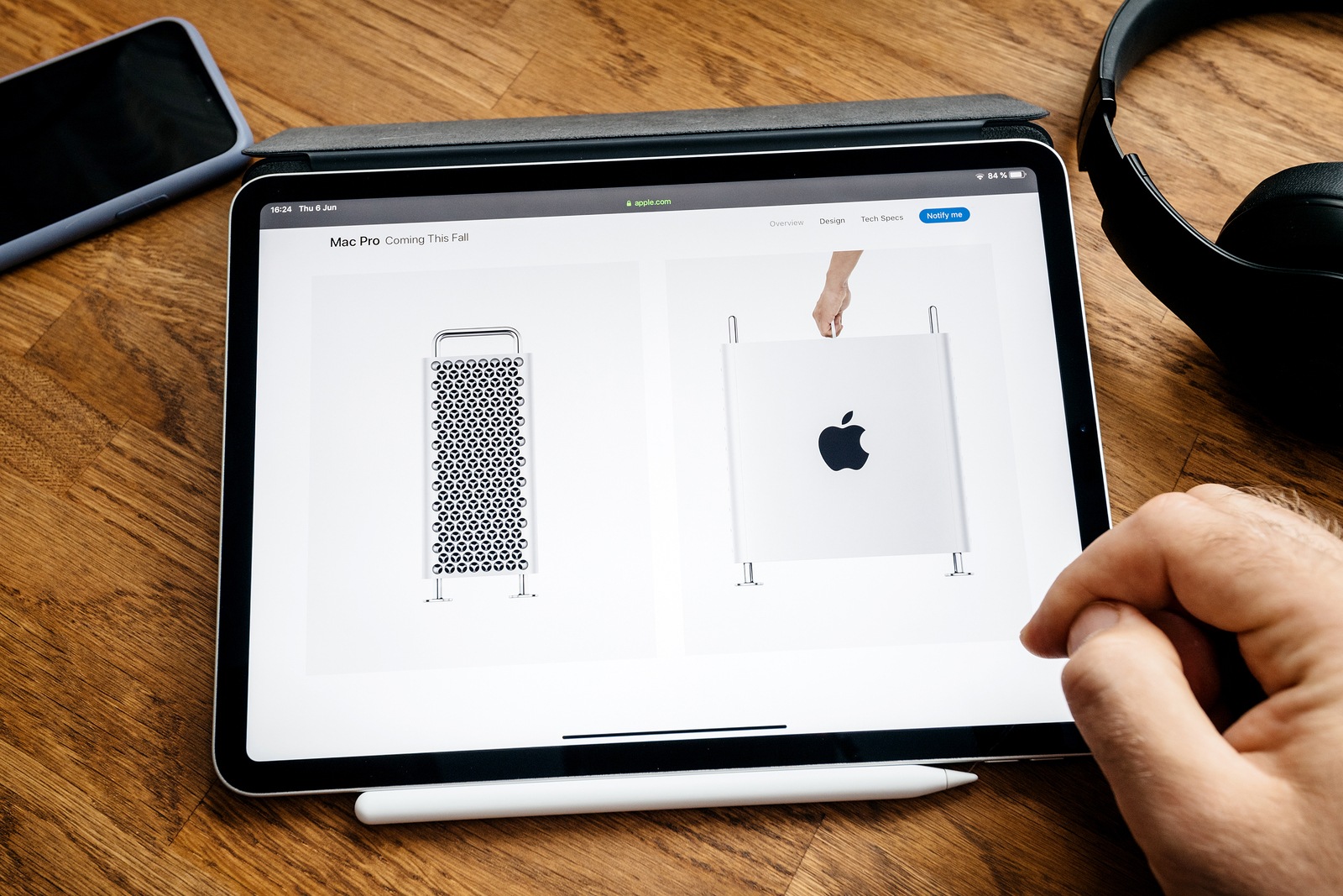 Paris, France - Jun 6, 2019: Man reading on Apple iPad Pro tablet about latest announcement of at Apple Worldwide Developers Conference WWDC - showing the new Mac Pro workstation and top handle
