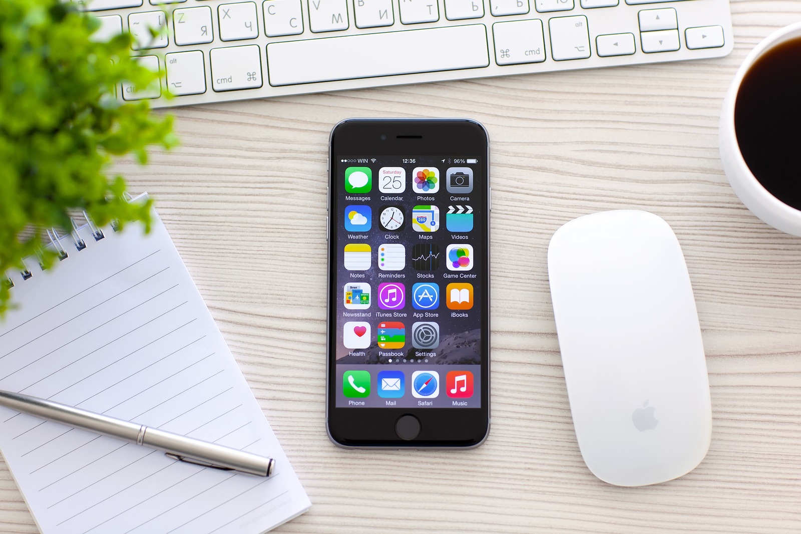 Alushta Russia - October 25 2014: New phone iPhone 6 Space Gray with apps on screen lies on the table. iPhone 6 was created and developed by the Apple inc.