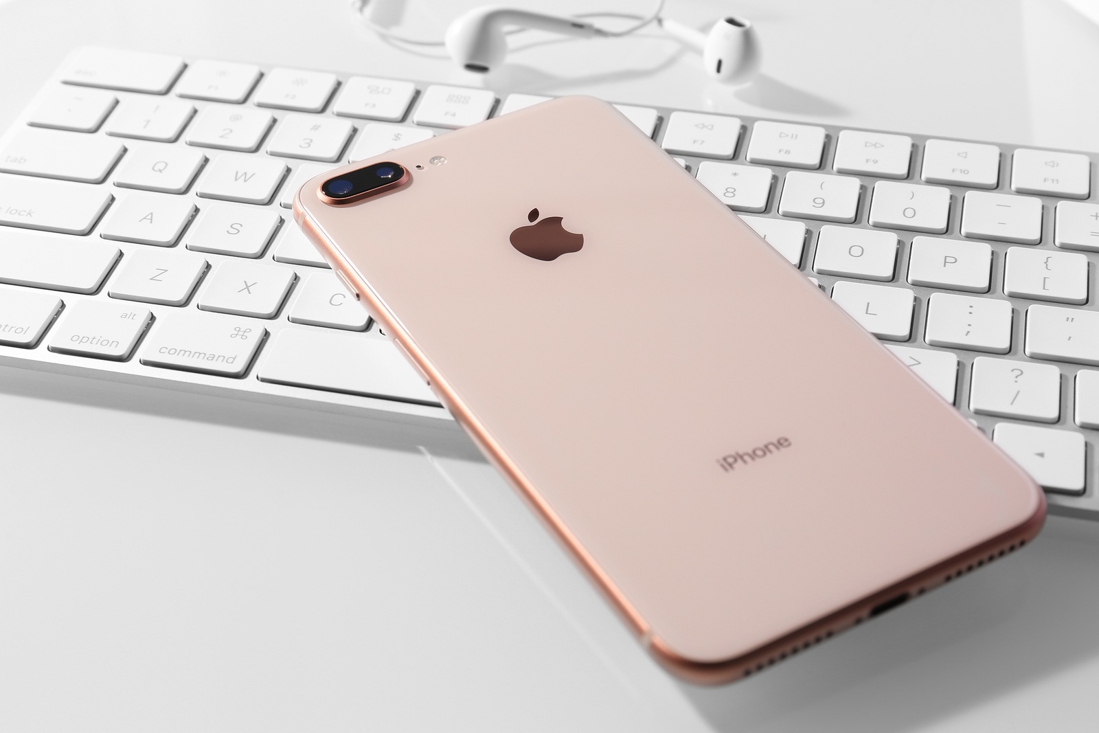 KIEV, UKRAINE - OCTOBER 23, 2017: iPhone 8 Plus Gold on computer keyboard, closeup
