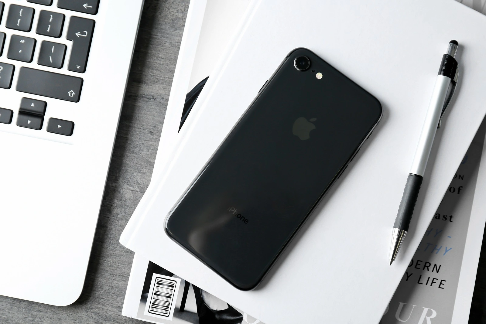 KYIV, UKRAINE - DECEMBER 5, 2017: Back panel of iPhone 8 Space Grey on notebook