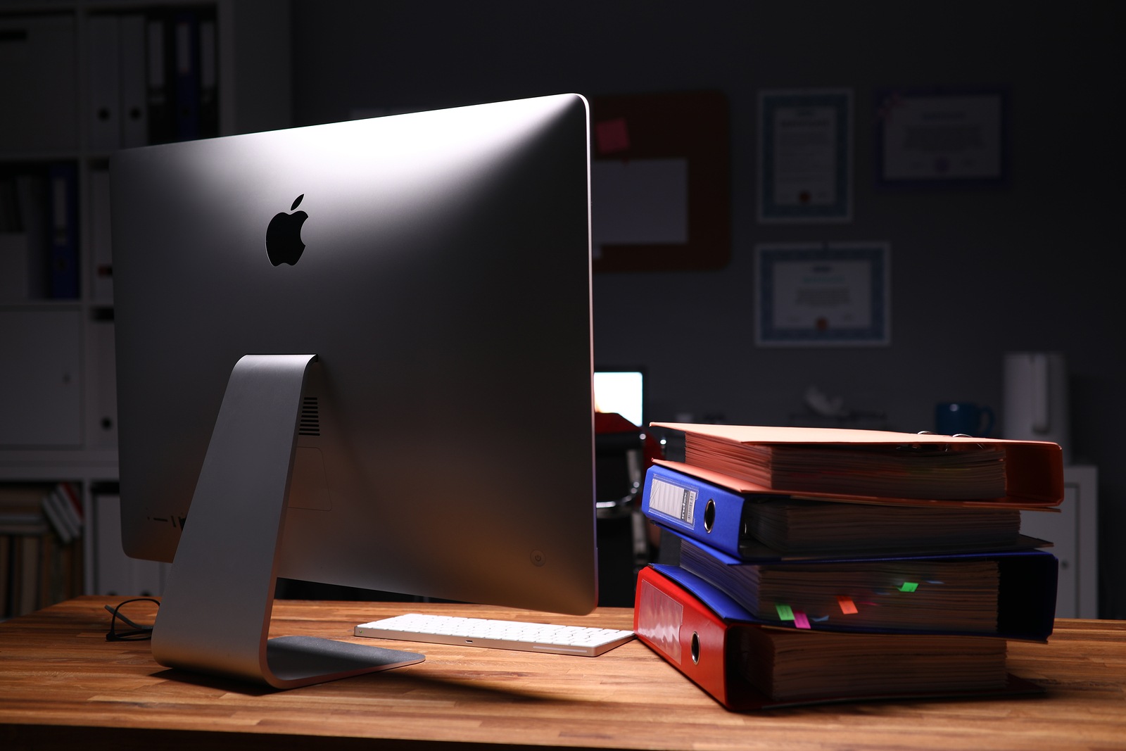 Minsk, Belarus - 5 December 2019: Apple imac computer aganist empty office background. Illustrtive editorial image.