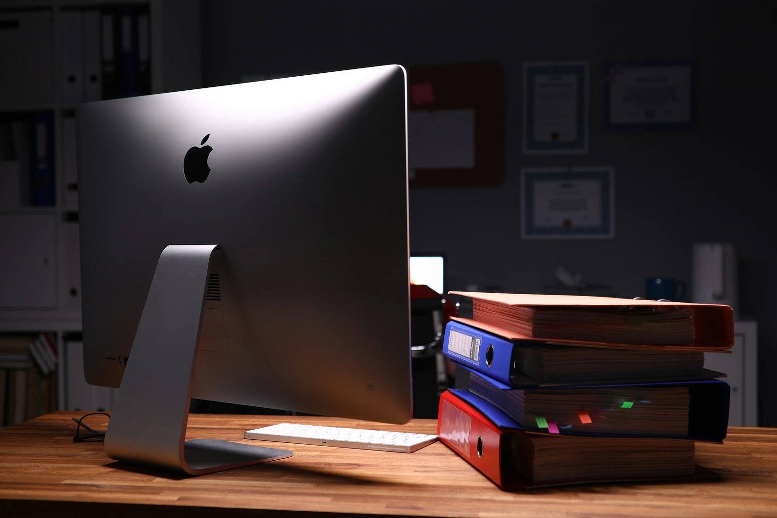 Minsk, Belarus - 5 December 2019: Apple imac computer aganist empty office background. Illustrtive editorial image.