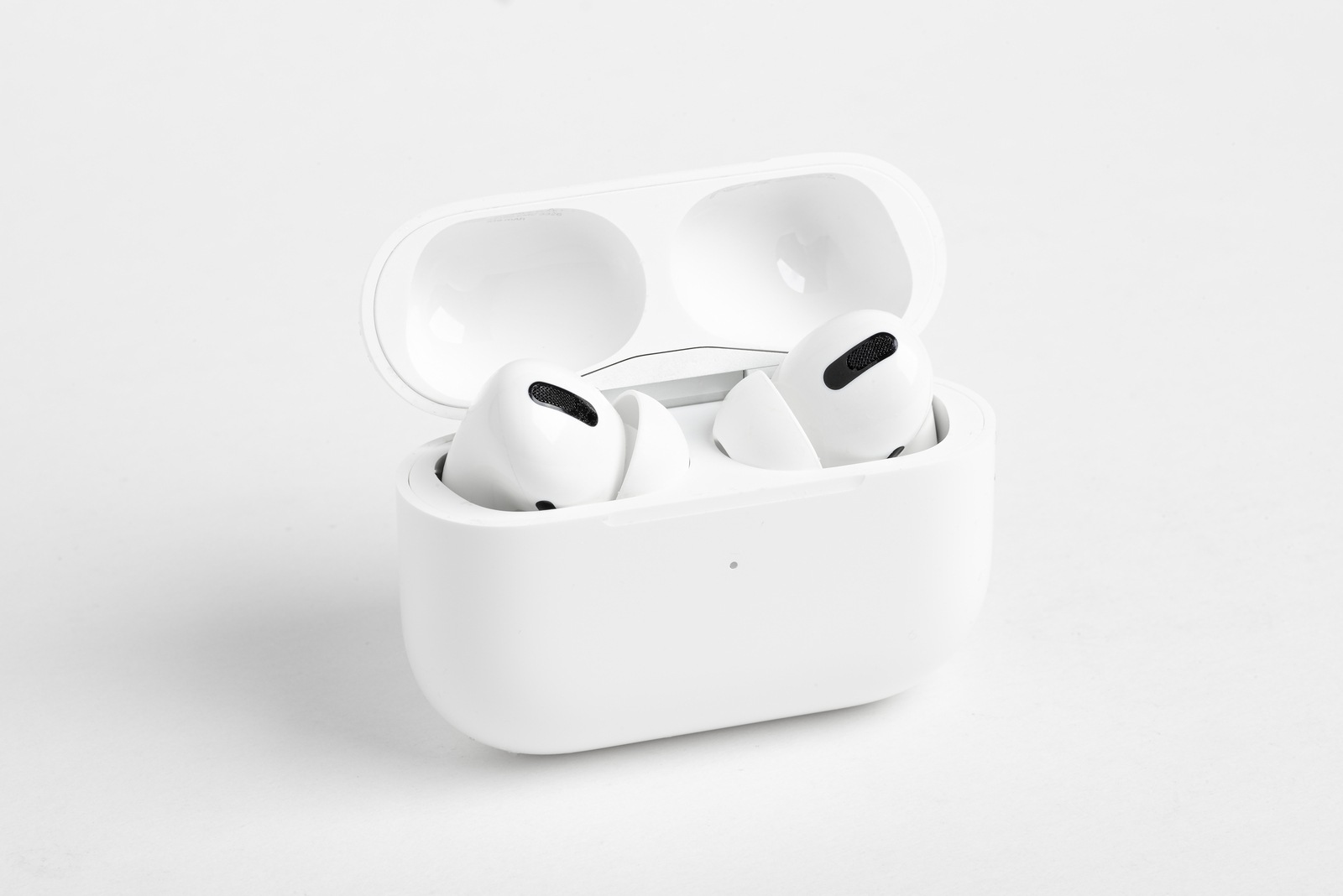 Vidalia, Georgia / USA - December 14, 2019 - A studio product shot of the Apple AirPods Pro buds nestled inside its open charging case set on a plain light color background.