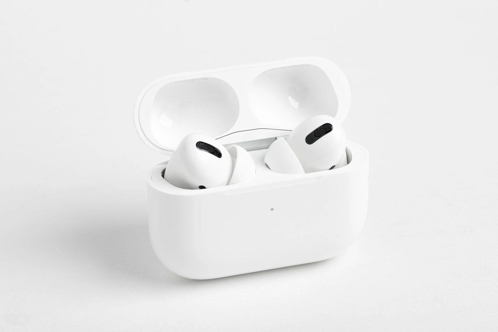 Vidalia, Georgia / USA - December 14, 2019 - A studio product shot of the Apple AirPods Pro buds nestled inside its open charging case set on a plain light color background.