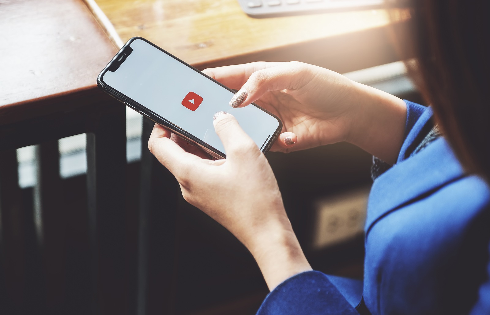 CHIANG MAI, THAILAND - Feb 16, 2019: A woman showing screen shot of YouTube on iphone x, YouTube app on the screen, YouTube is the popular online video sharing website. -Image