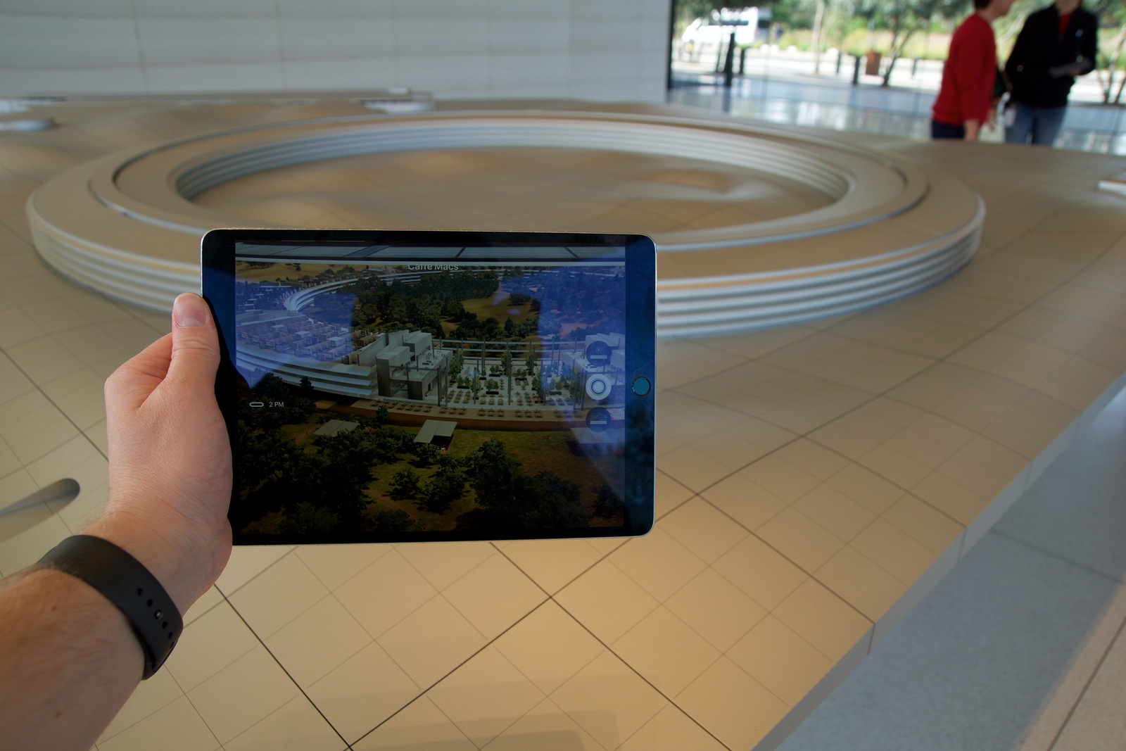 CUPERTINO, CALIFORNIA, UNITED STATES - NOV 26th, 2018: People at the Apple Park Visitor Center in Silicon Valley explore the new Apple Offices using a scaled-down replica of the campus and a virtual reality program