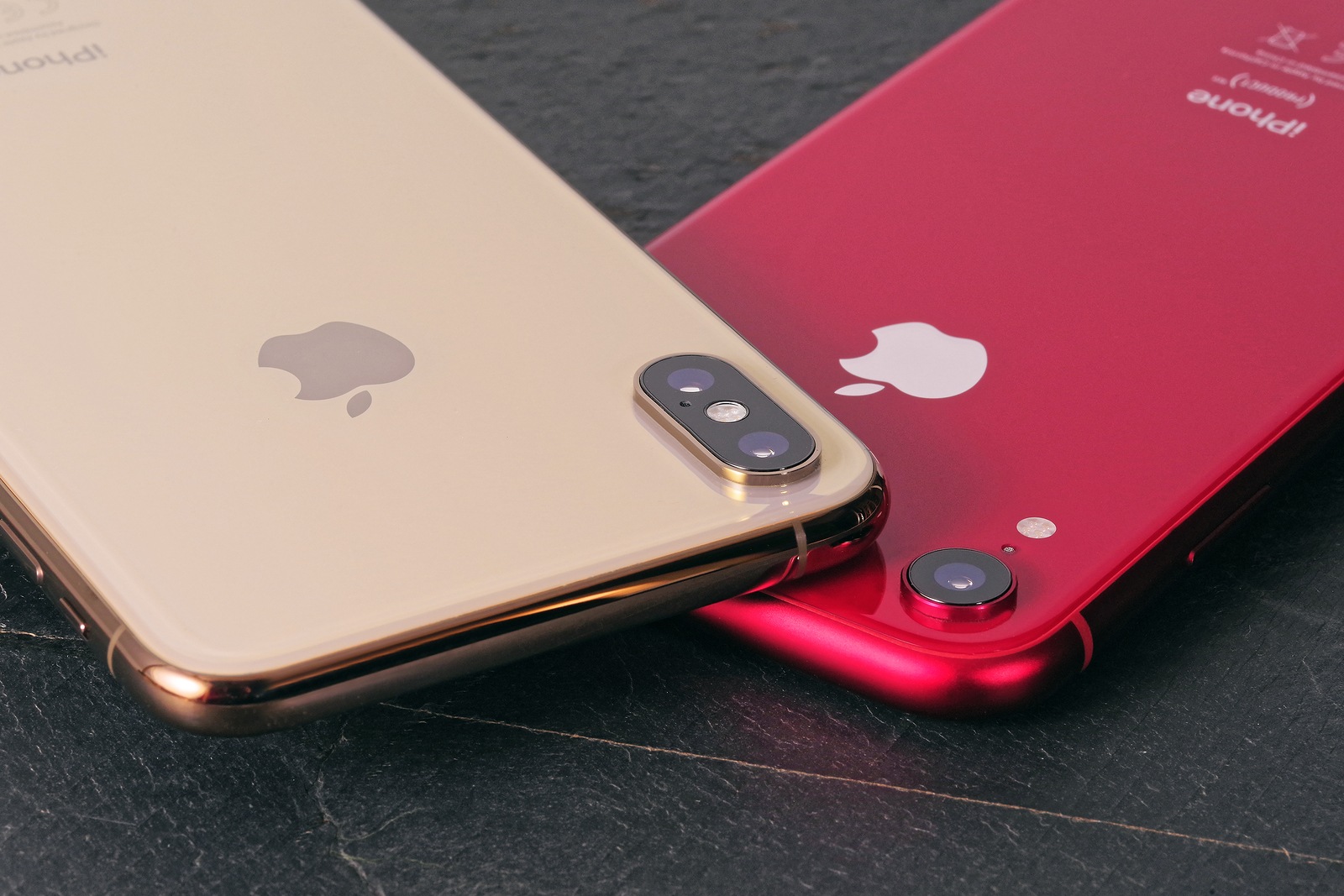 Koszalin, Poland - November 12, 2018: Golden iPhone XS Max and red iPhone XR. The iPhone XS Max and iPhone XR is smart phone with multi touch screen produced by Apple Computer, Inc.