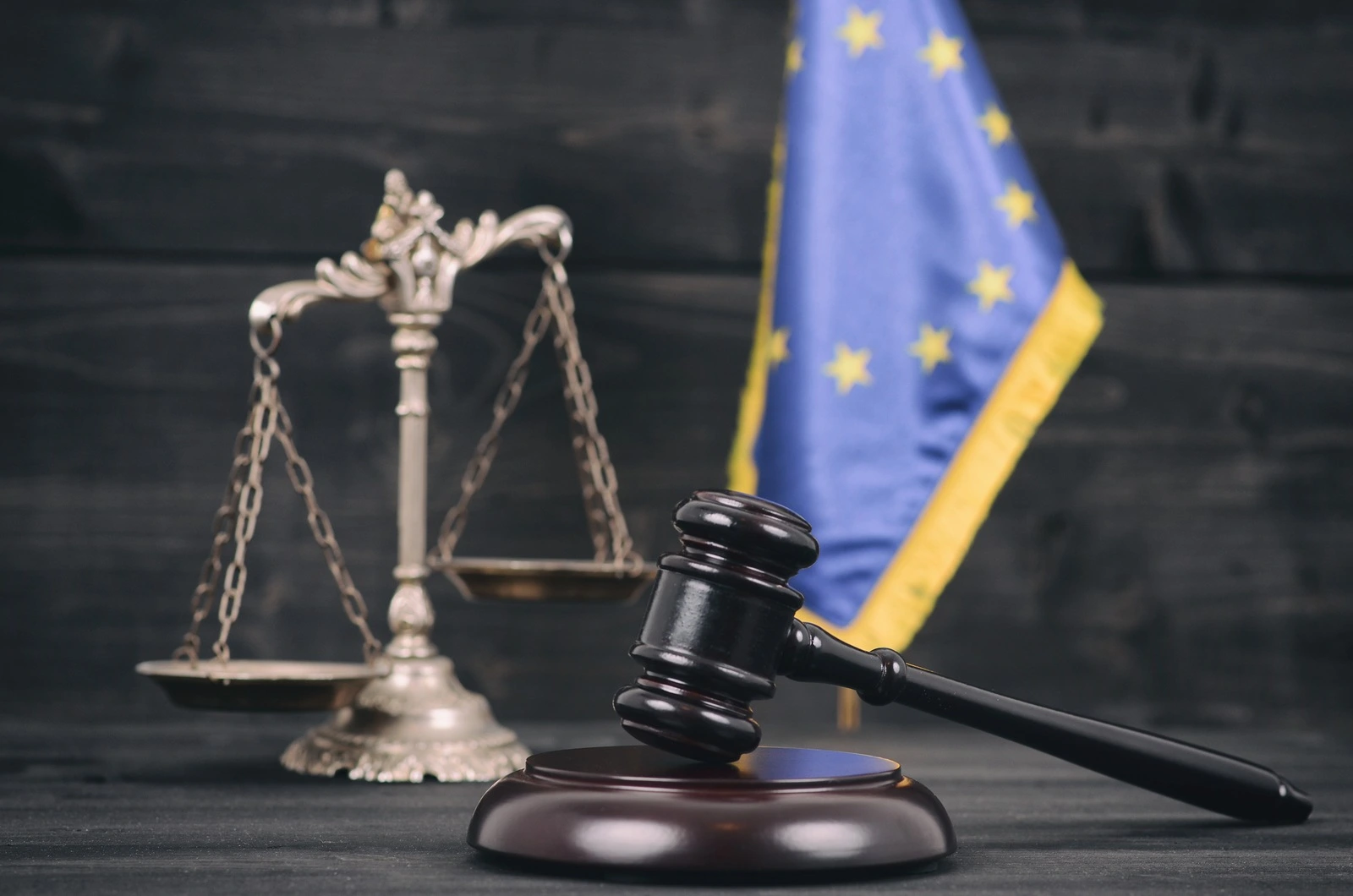 Law and Justice , Legality concept, Scales of Justice, Judge Gavel andFlag of the European Union on a black wooden background.