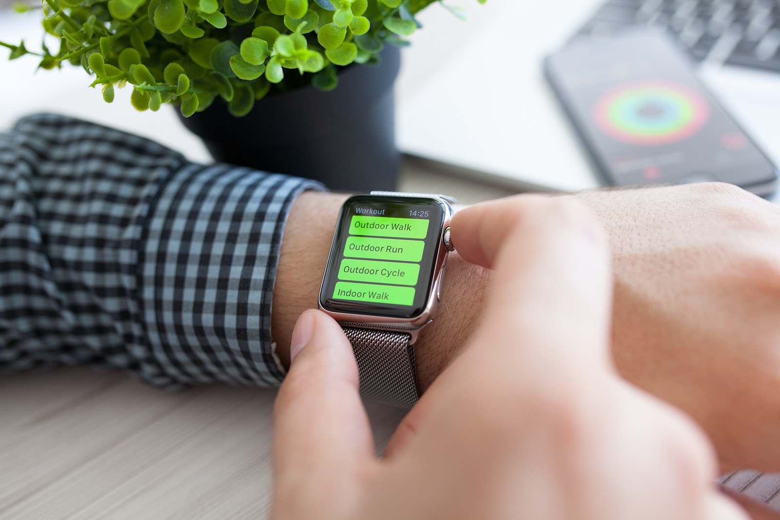 Alushta Russia - August 14 2015: Man hand with Apple Watch and app Workout on the screen. Apple Watch was created and developed by the Apple inc.
** Note: Shallow depth of field
