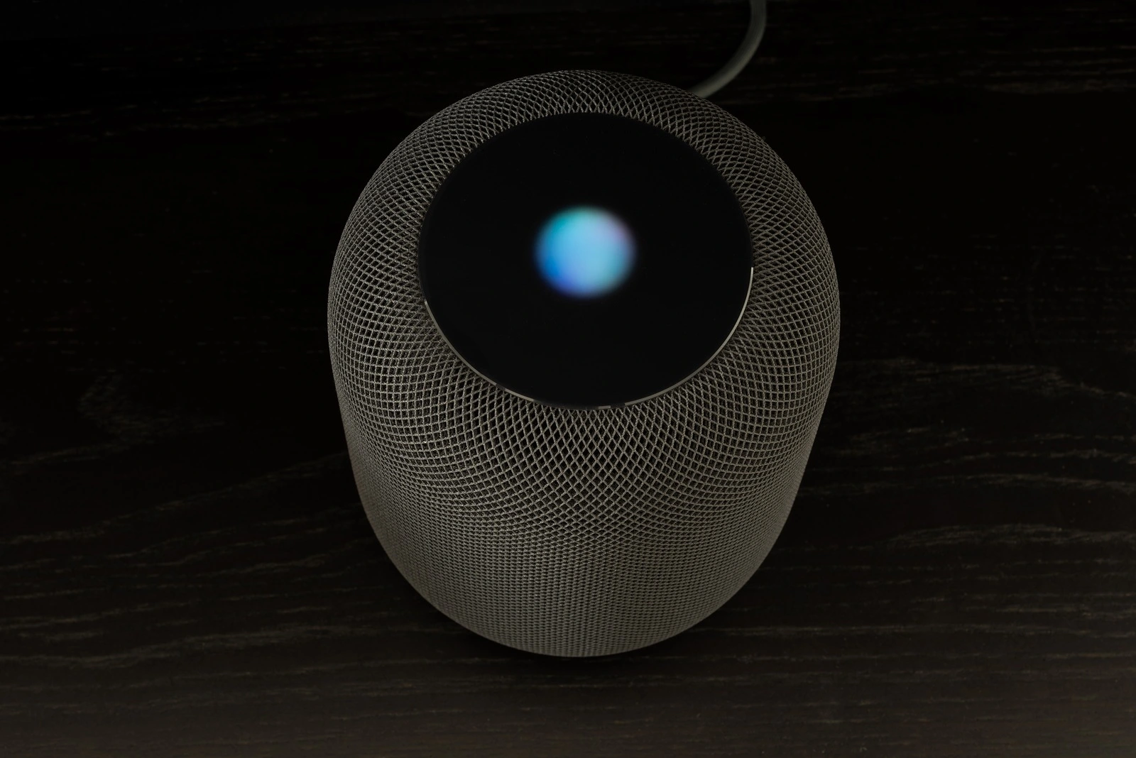 Ostfildern, Germany - June 26, 2018: Using an Apple HomePod speaker - the smart speaker is reacting to voice input and signalling its attention by the changing lights