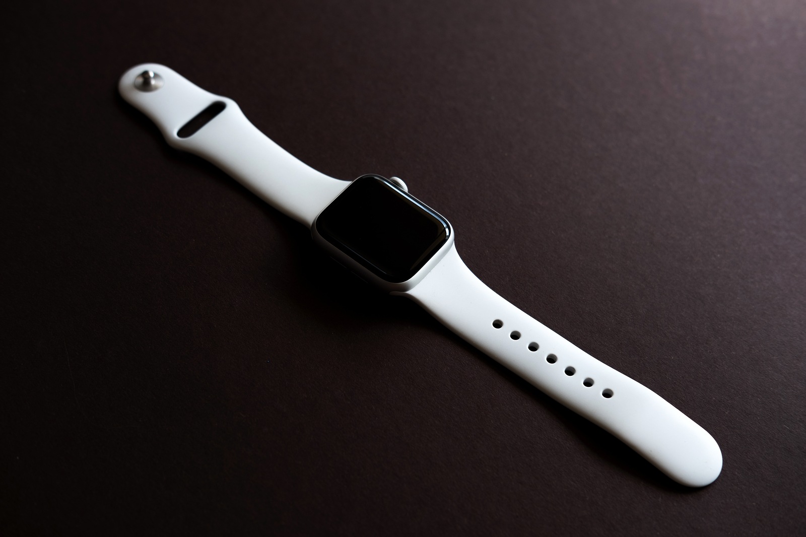 Chekhov, Russia - July 19, 2019: Apple Watch Series 4 white color. A new watch from an Apple company closeup isolated on dark background