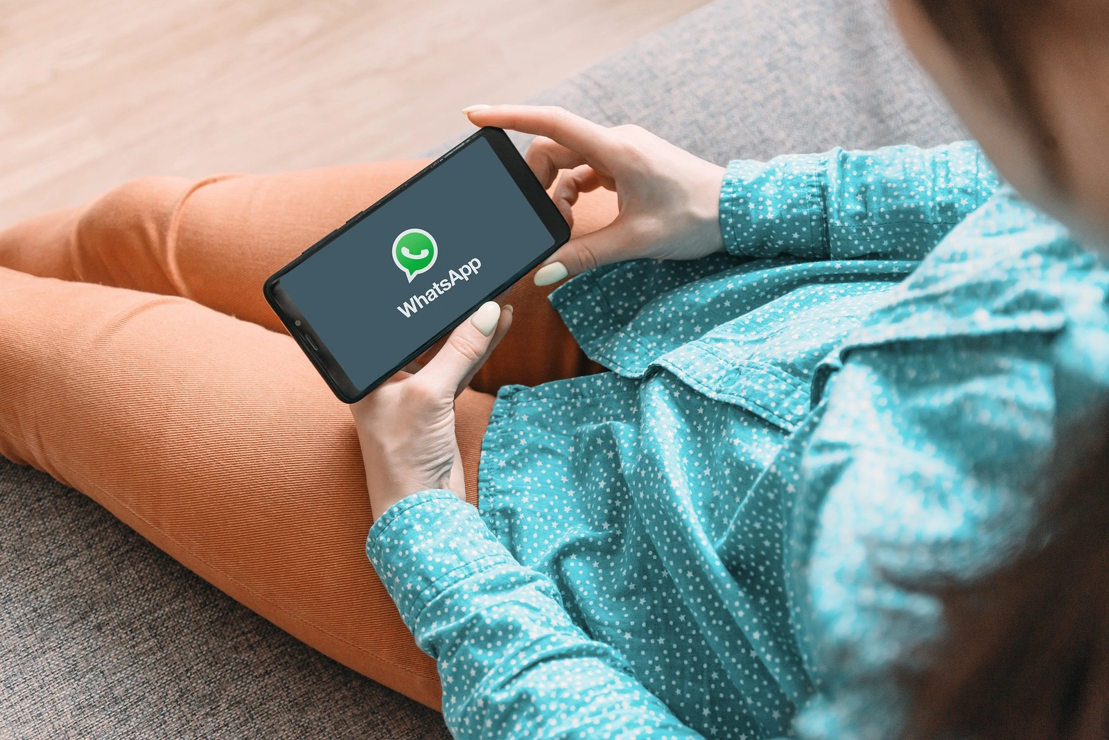 Gelendzhik, Russia, 19 November 2019: Young woman using WhatsApp on her cellphone at home.