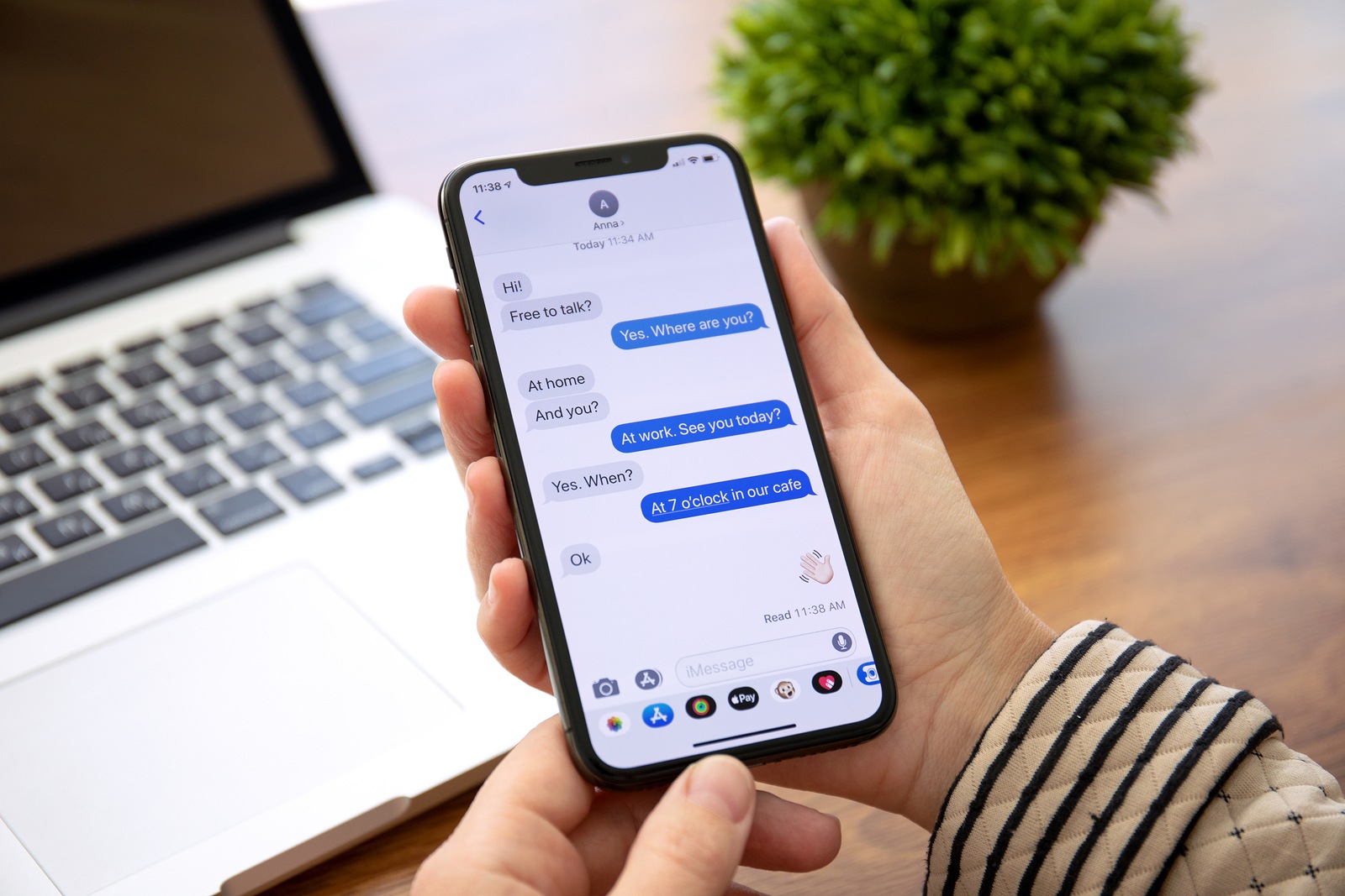 Alushta, Russia - September 26, 2018: Woman hand holding iPhone X with social networking service iMessage on the screen. iPhone 10 was created and developed by the Apple inc.