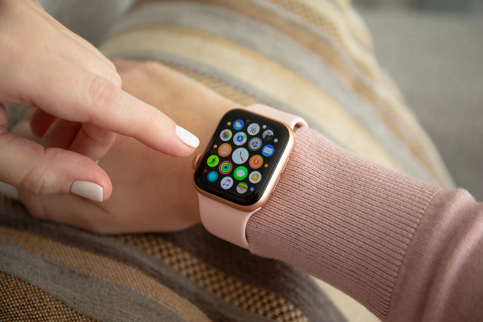 Anapa, Russia - February 16, 2019: Woman hand with Apple Watch Series 4 and finger touching screen. Apple Watch was created and developed by the Apple inc.
