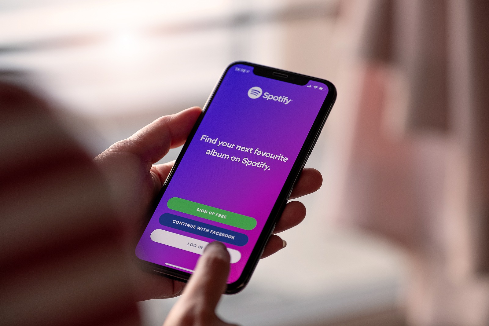 CHIANG MAI, THAILAND - NOV 17 2019: Person holding Apple iPhone XS with Spotify