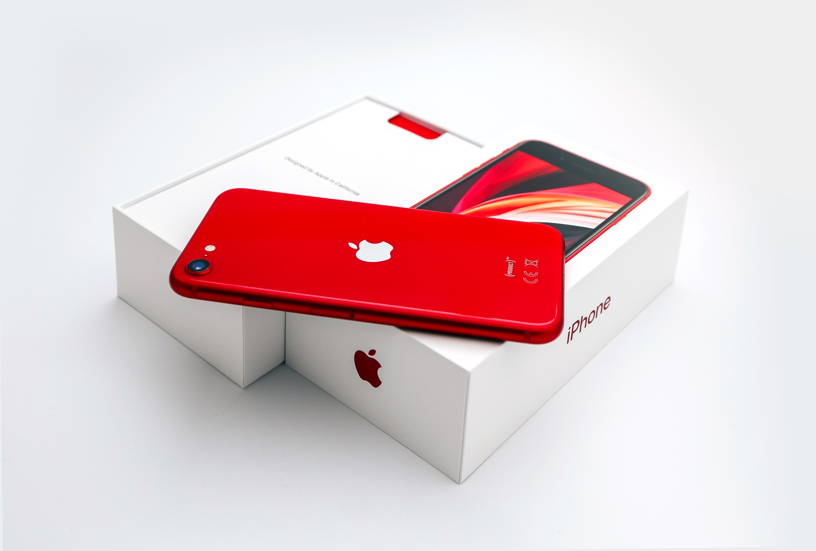 France, Paris - May 1, 2020: A new red Apple iPhone SE 2nd generation in a box on white background.