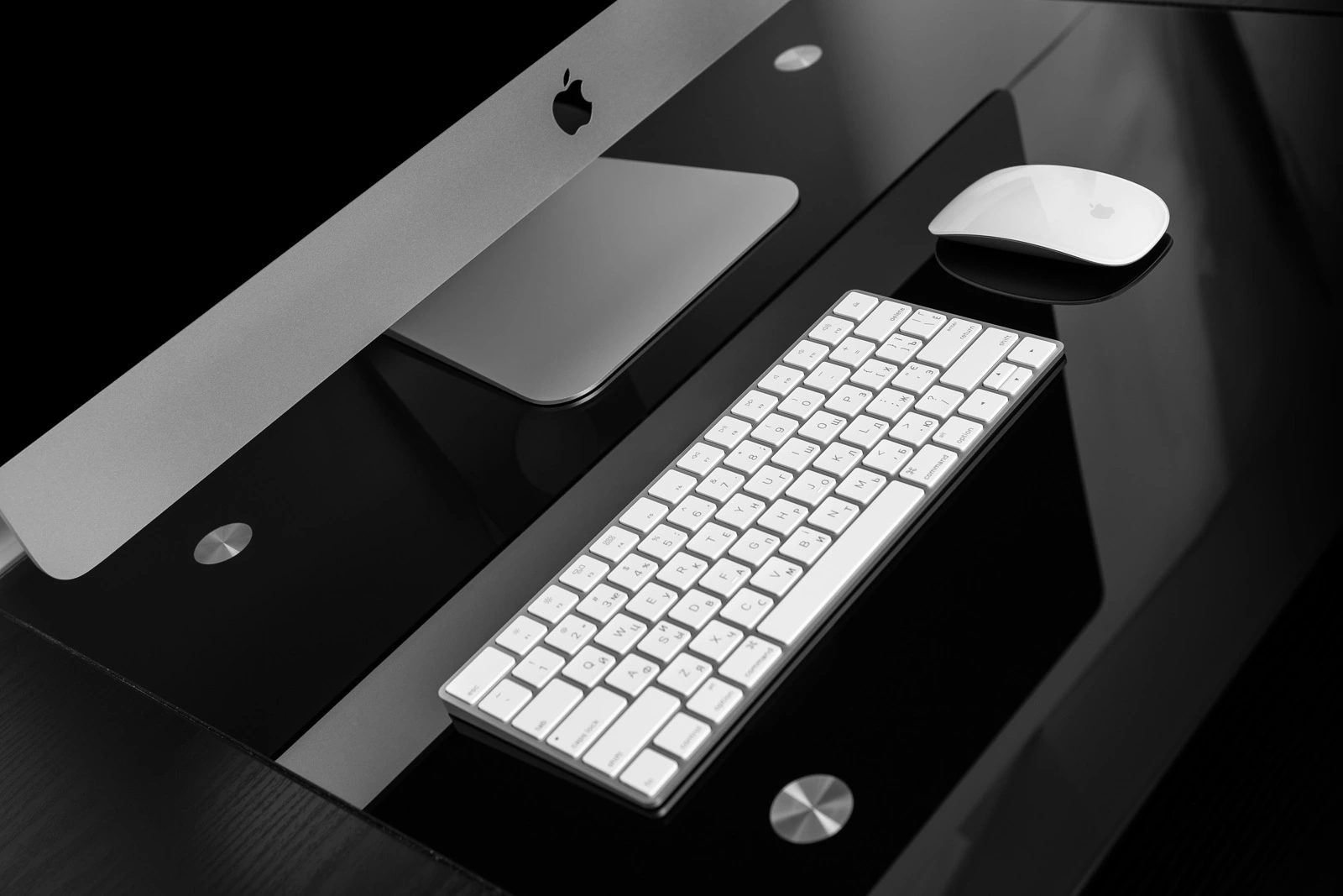 UKRAINE, RIVNE, December 2, 2016. Apple Computer iMac 27 retina display 5K keyboard and magic mouse on black table.