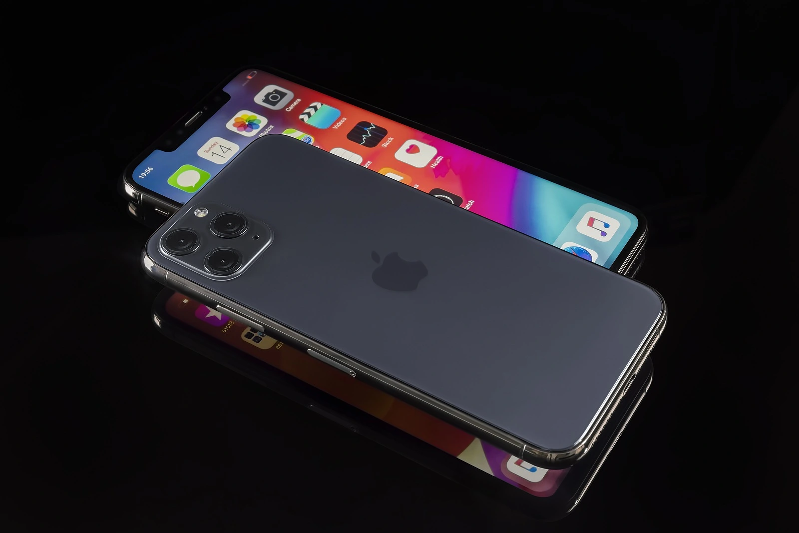 Galati, Romania - March 23, 2020: Apple launch the new smartphone iPhone 11 Pro and iPhone 11 Pro Max. iPhone Pro Max front view and iPhone 11 Pro back view on black background. Focus on camera.